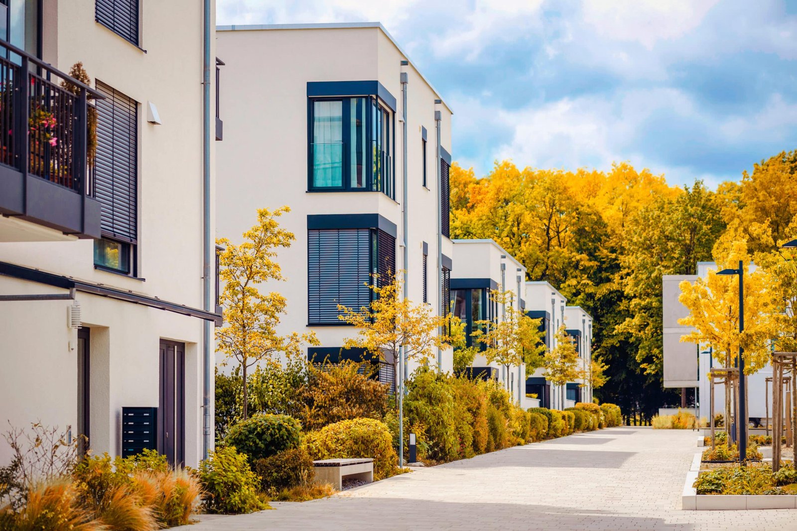 Autumn Landscape of Residential Apartment Building. Modern Facade Building on Fall Autumn Background.